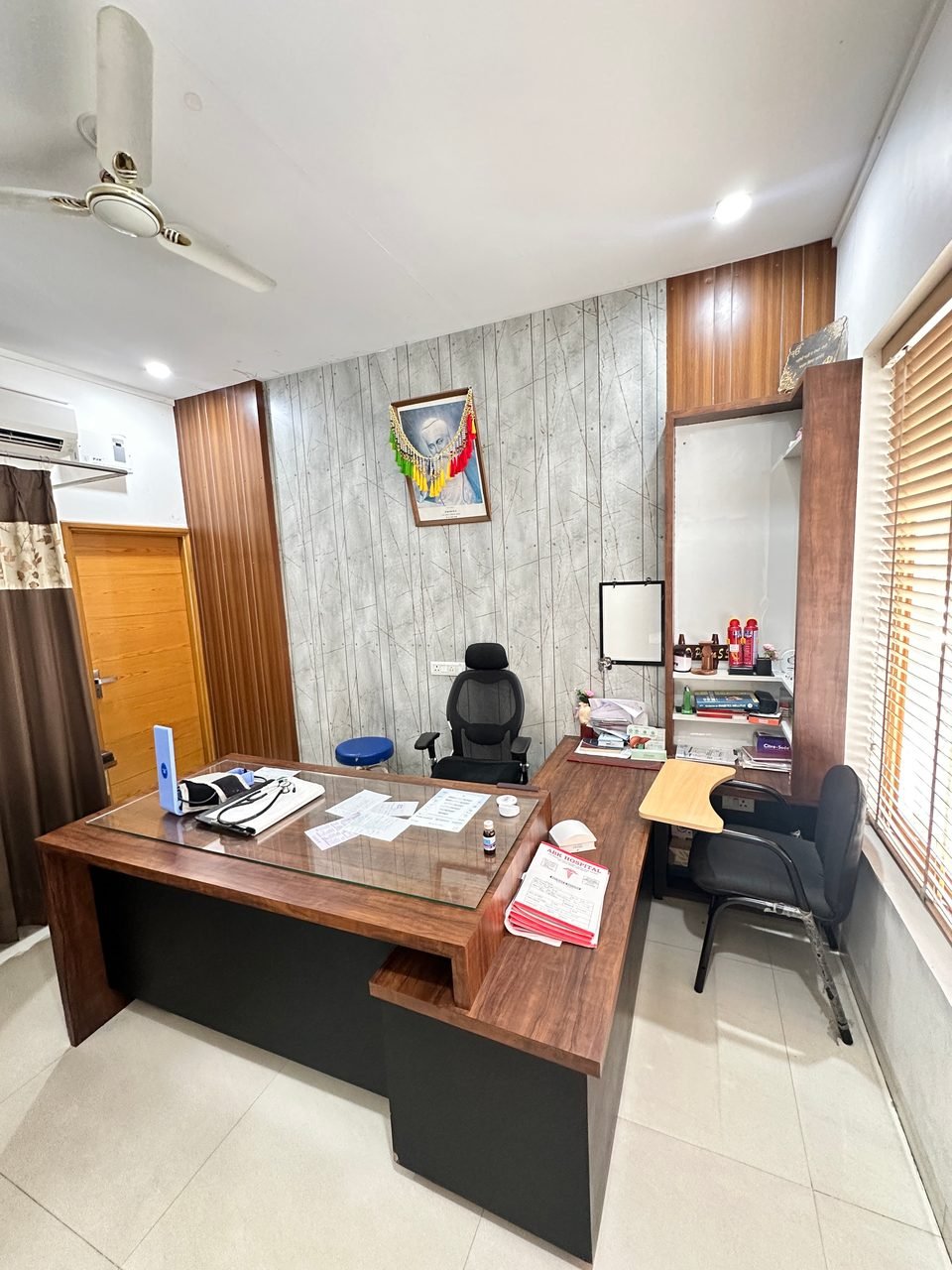 Consultation room with a doctor's desk and chairs